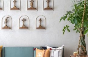 Traditional Wall Decor with Brass Idols and Elegant Seating